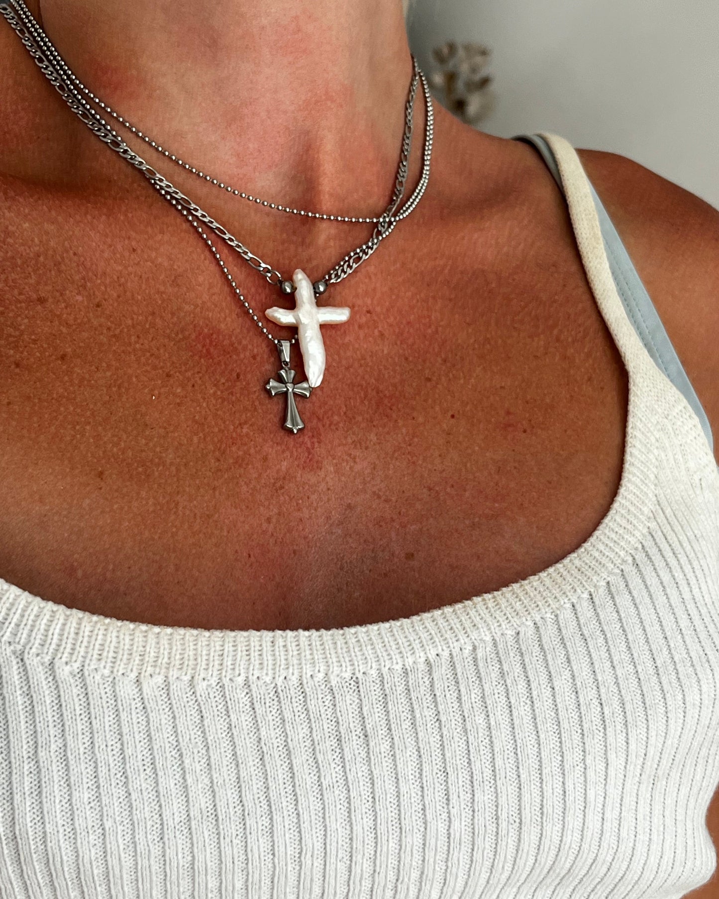 Unisex silver cross pendant necklace worn around neck, sterling steel chain jewelry for men and women