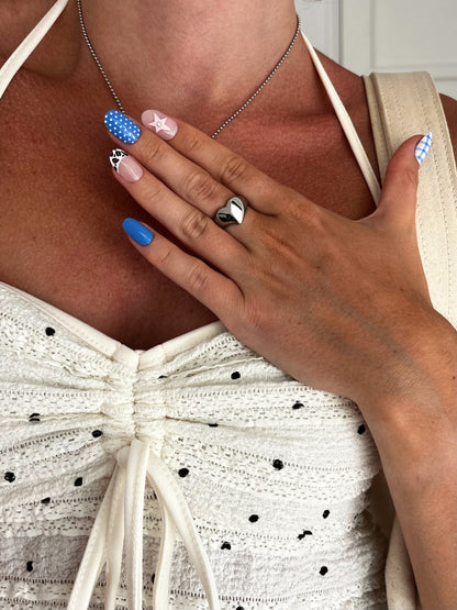 Closeup of LOVIE ring showing heart-shaped design and polished silver finish, unisex statement piece.