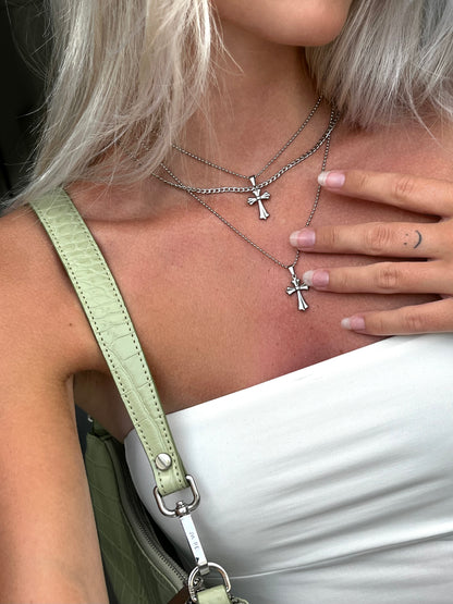 Styled unisex silver stainless steel cross pendant necklace worn around neck, chain necklace jewelry for men and women