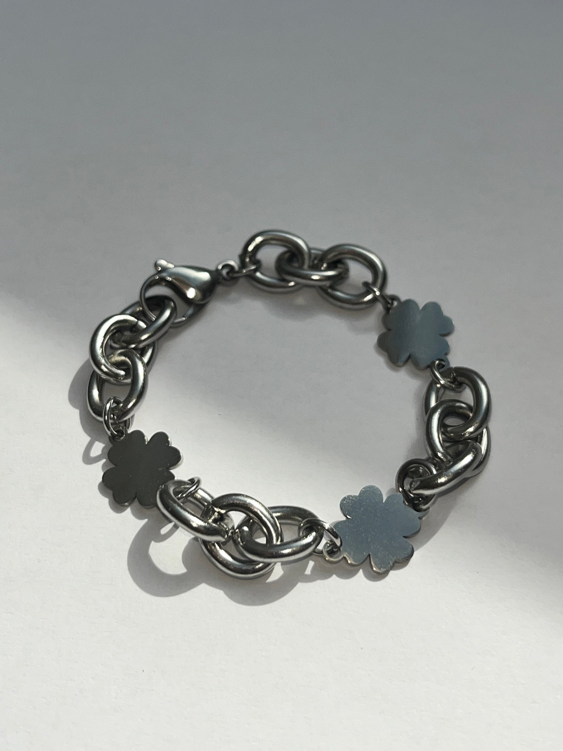 Product image of closeup unisex chunky clover charms chain bracelet in silver stainless steel, water and sweat proof