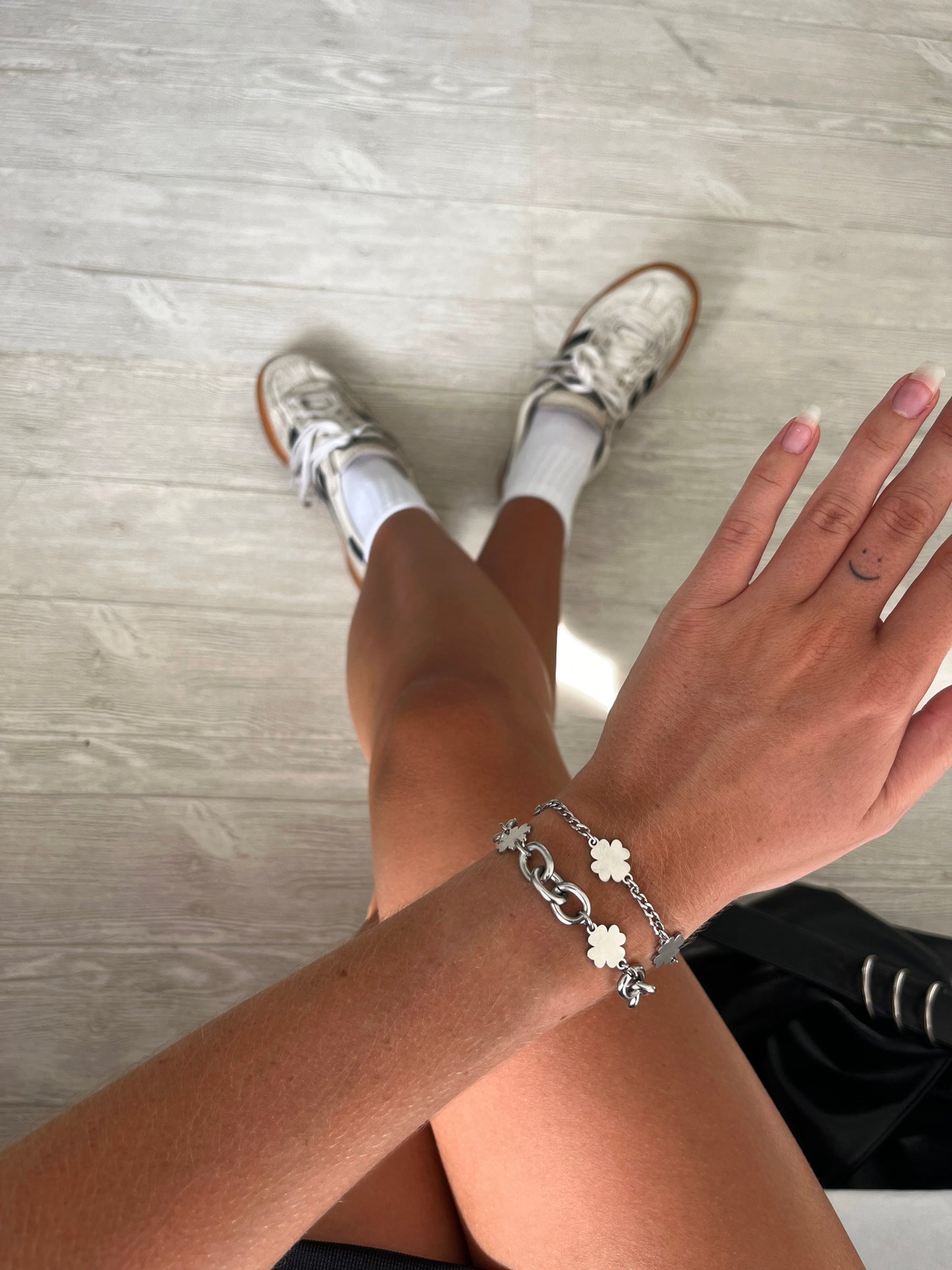 model wearing a unisex slim clover charms chain bracelet in silver stainless steel, water and sweat proof
