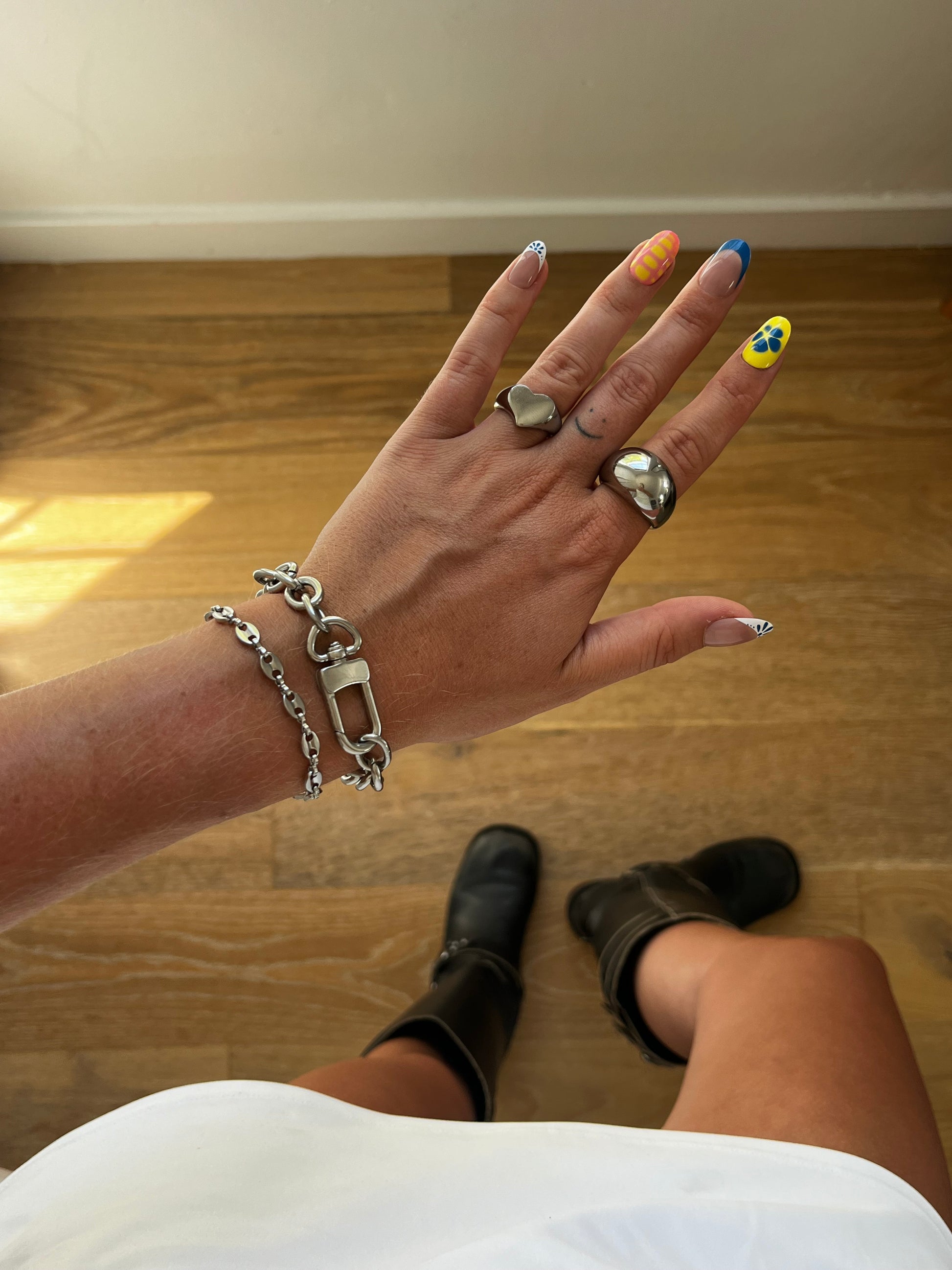 Hand styled with multiple stainless steel karliekarlo rings and bracelets focusing on the grand clasp bracelet