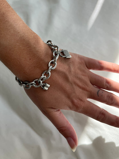 Sideways view of unisex chunky padlock link bracelet in silver stainless steel, water and sweat proof