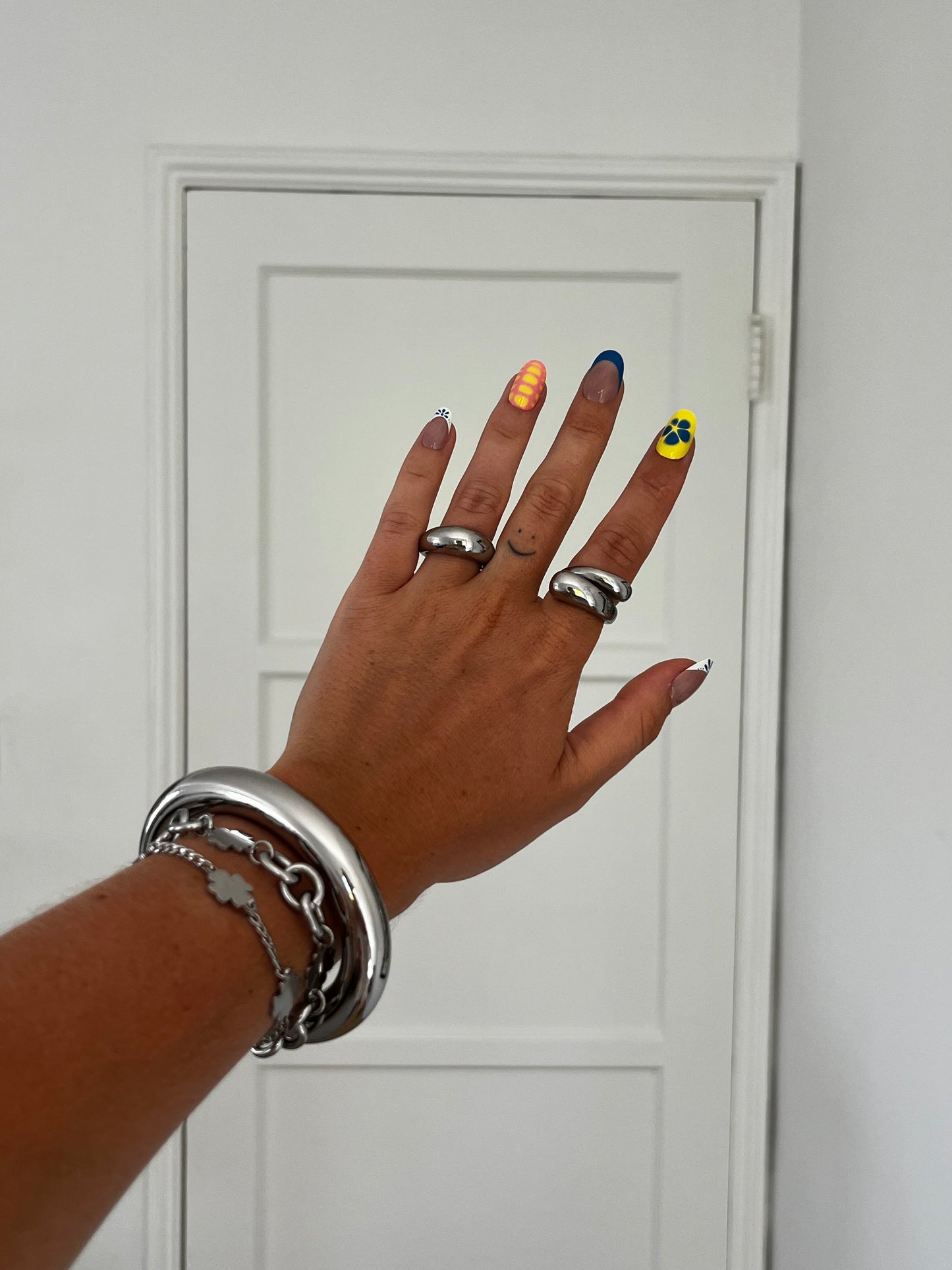 unisex silver stainless steel spin wrap around dome ring, statement jewelry for men and women styled with small dome ring and clean bangle