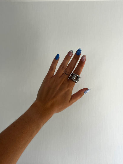 Detailed view of THE CHUNKER ring showing polished interlocked loops, chunky stainless steel unisex statement jewelry