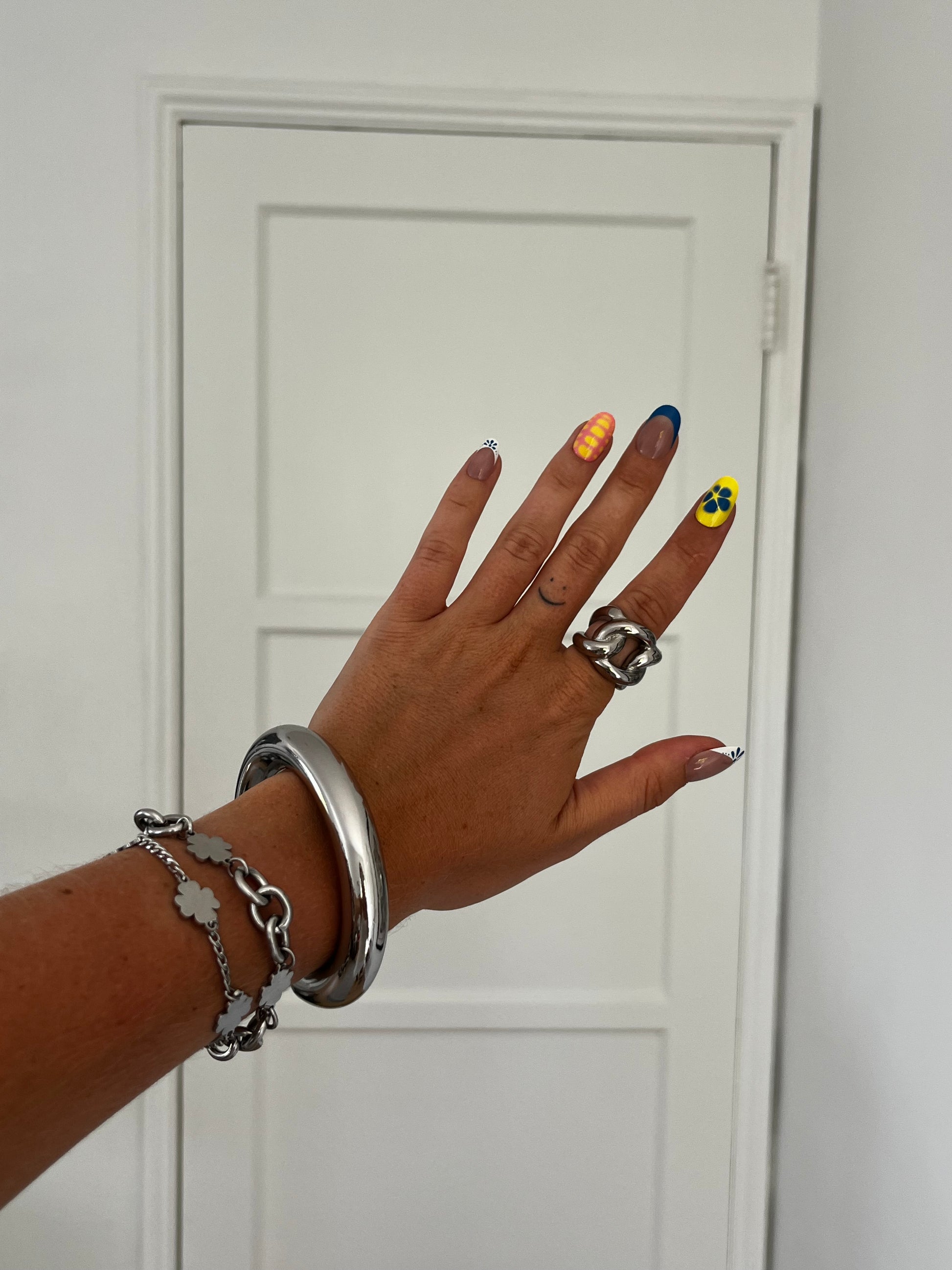 Angled view of THE CHUNKER ring with interlocked loops, high-polish stainless steel unisex statement piece.