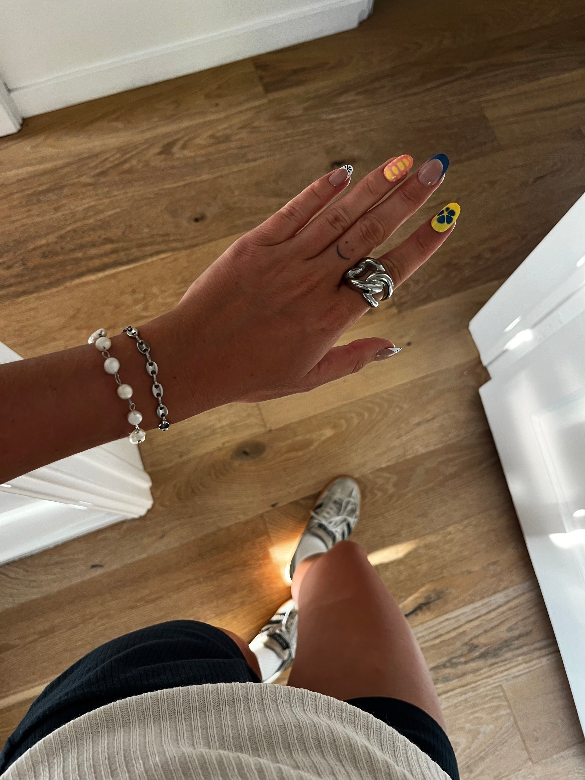 Styled model wearing THE CHUNKER chunky interlocked loop stainless steel ring, bold unisex jewelry.