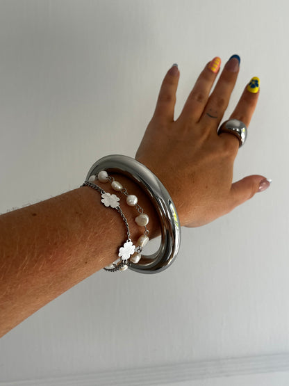 Side view of THE CLEAN BANGLE showing sleek polished stainless steel design, unisex statement piece