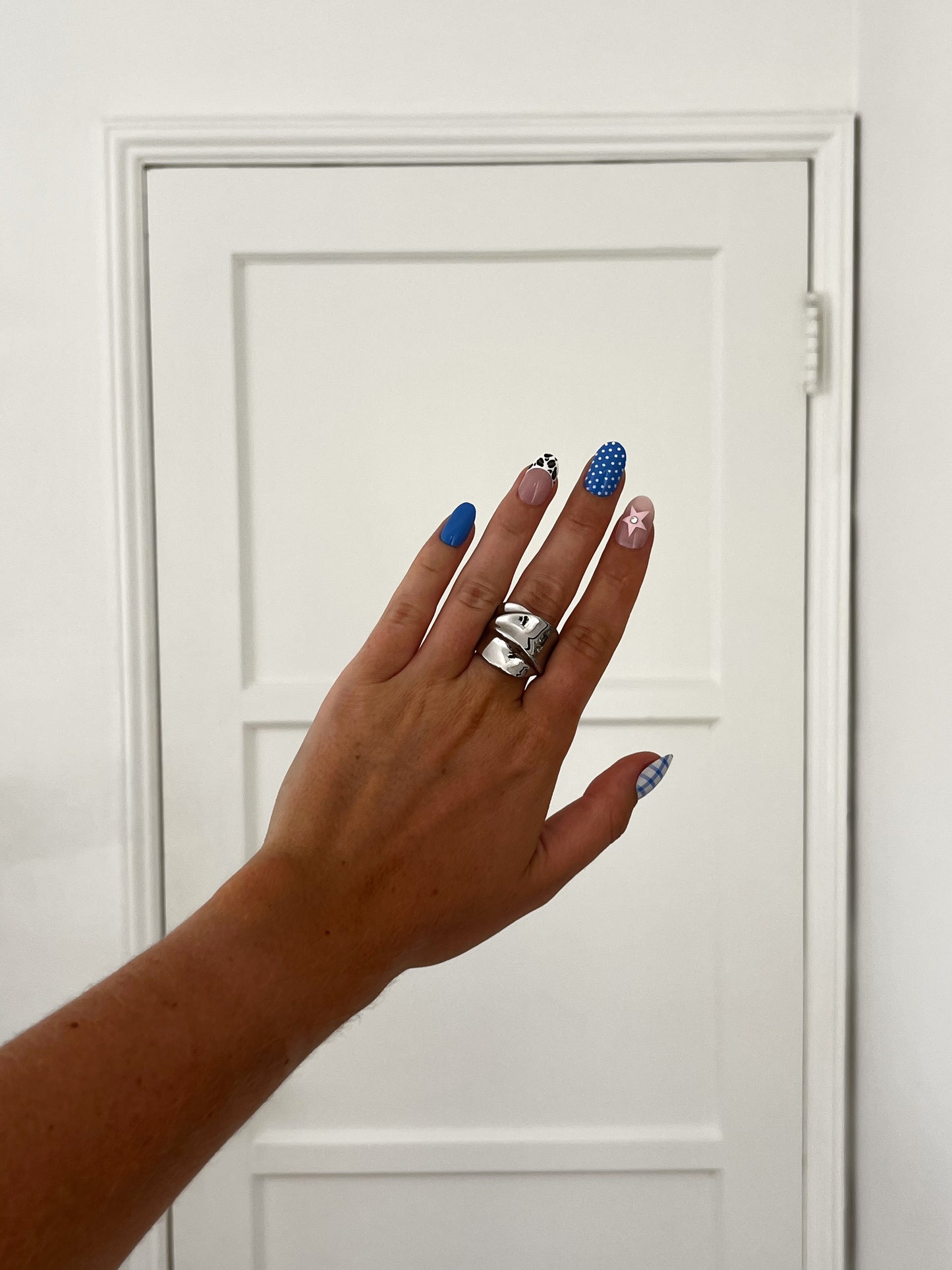 Closeup of THE CROSSOVER ring highlighting folded chunky design, high-polish stainless steel unisex statement piece