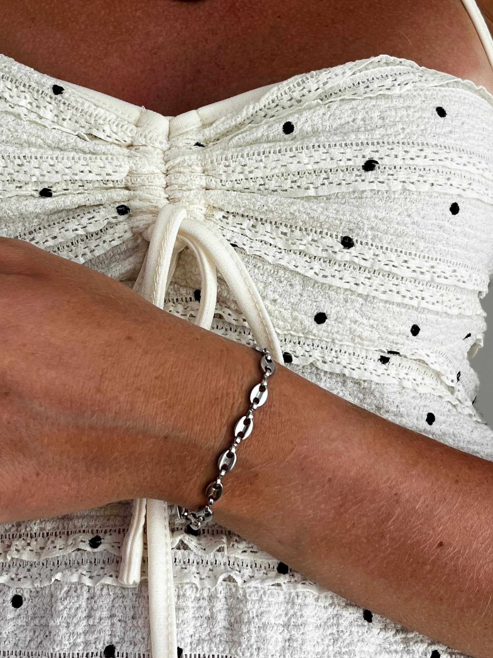 Model wearing THE FLETCHER stainless steel coffee-bean link bracelet, layered or solo, unisex jewelry.