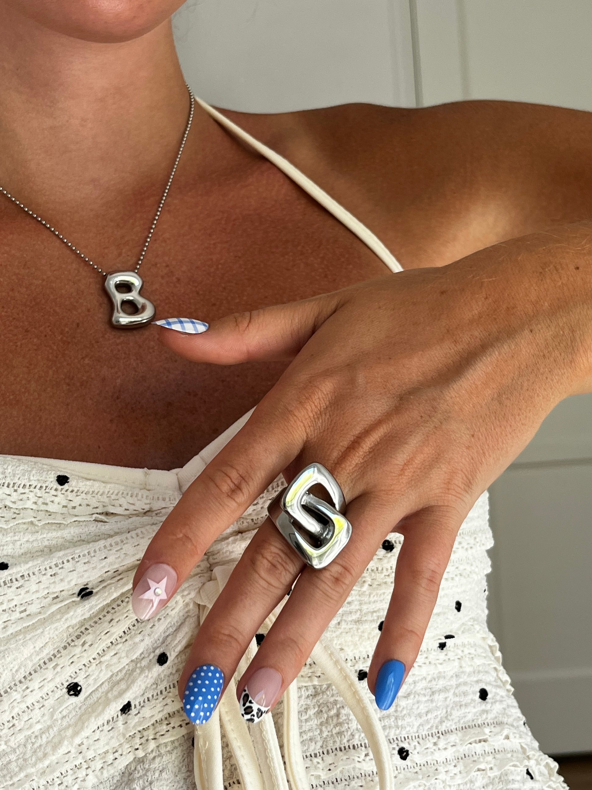 Closeup of THE KARL stainless steel ring highlighting cut-out geometric design, bold unisex statement piece