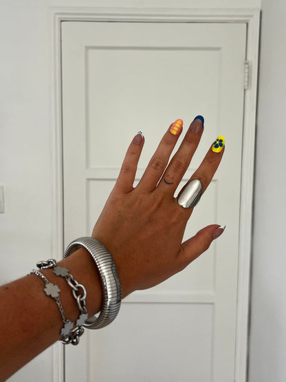 Model wearing THE OVA high-gloss stainless steel ring, bold unisex statement jewelry