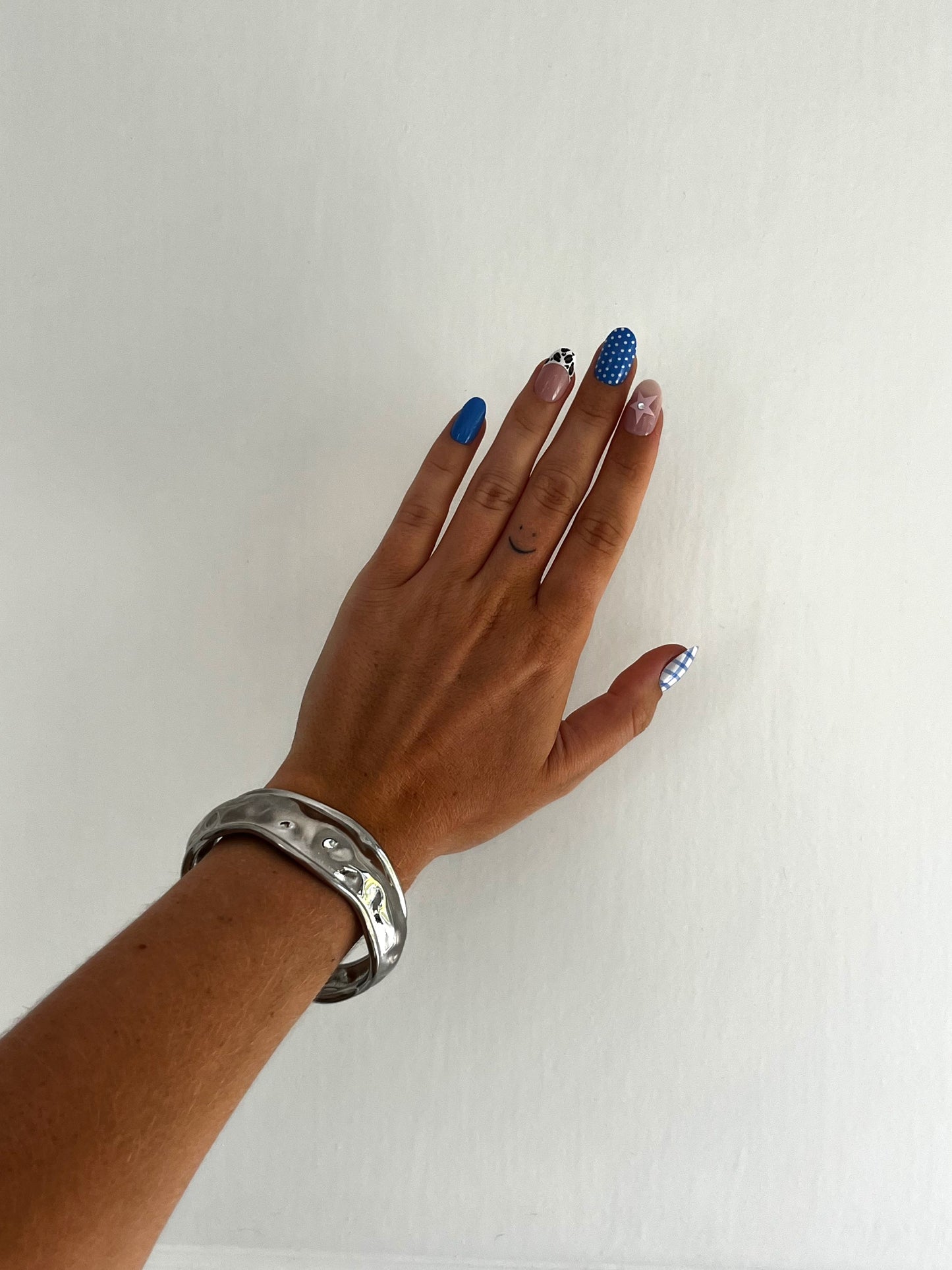 Model wearing THE TEXTURED BANGLE stacked or solo, hammered stainless steel unisex statement jewelry