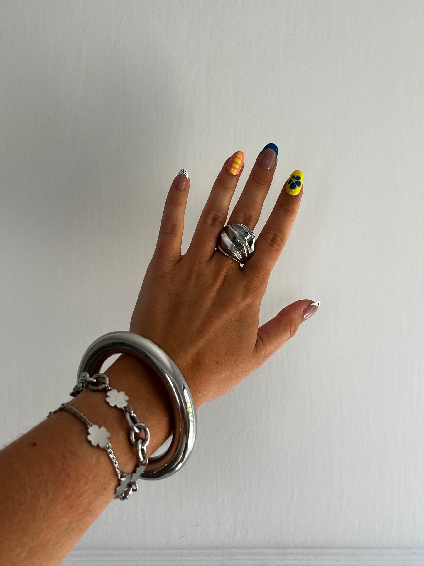 Closeup of THE WHORL stainless steel silver ring showing fluid twisted design, heavy and bold unisex statement piece.